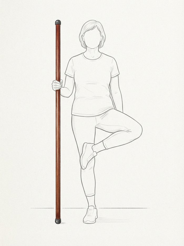 Figure-four hip opener balanced against the pole